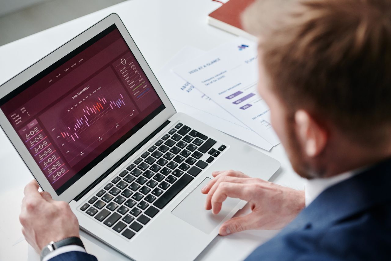 A settlement dashboard with charts open on a laptop