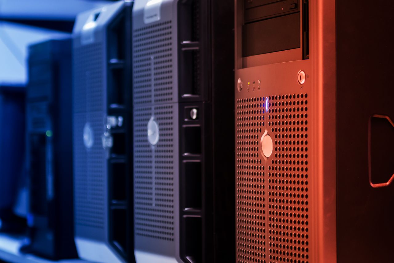 Rows of network racks lit in a server room